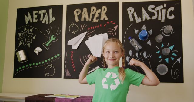 Happy caucasian girl wearing recycling t shirt in elementary school ecology class, copy space. Ecology, recycling, environmental awareness, childhood, education, learning and school, unaltered.