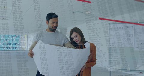 Business Professionals Collaborating on Financial Data Analysis in Modern Office