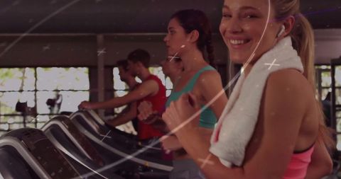 Group of Fit Individuals Exercising on Treadmills in Gym