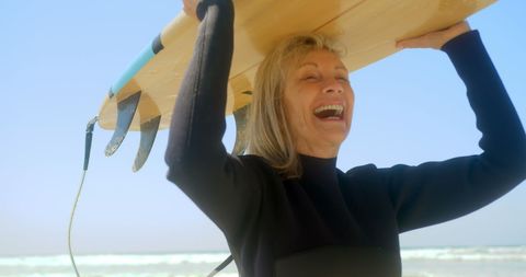 Senior Caucasian Woman Enjoying Surfing at Sunny Beach
