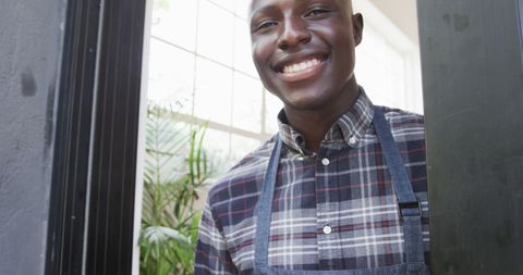 Smiling african american barista welcoming customers