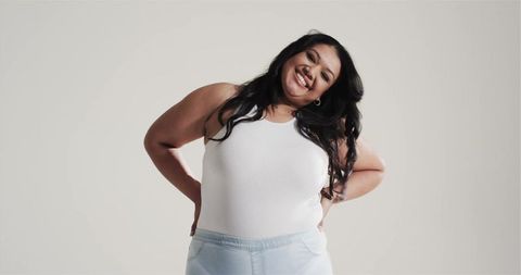 Smiling Woman in Minimalist Outfit Joyfully Posing