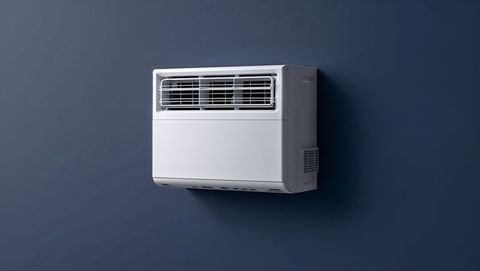 Modern wall-mounted air conditioning unit on blue background