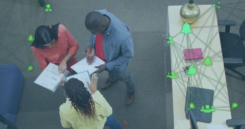 Diverse Business Team Analyzing Network Data in Modern Office