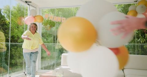 Senior Lesbian Couple Decorating for a Sunny Birthday Celebration