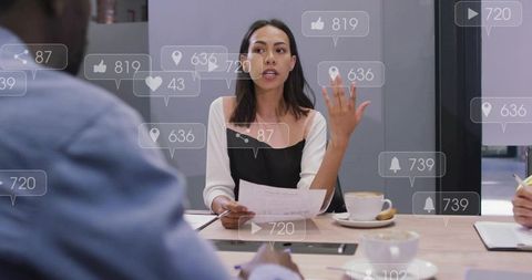 Businesswoman Presenting at Team Meeting with Social Media Engagement Overlays