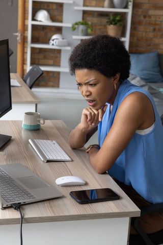 Professional Woman Focused on Completing Digital Task in Modern Office