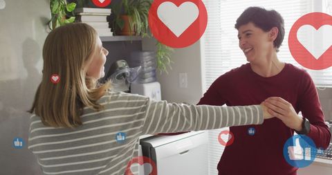 Happy Female Couple Enjoying Romantic Dance in Kitchen