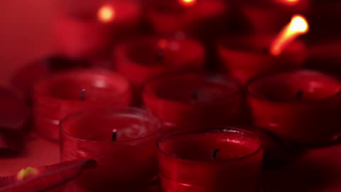 Dimly Lit Red Candles Twinkling in Soft Breeze