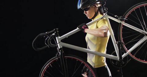 Cyclist carrying bicycle blur for endurance and competition concept