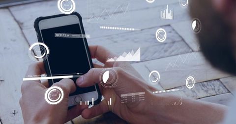 Hands holding smartphone with augmented data overlays showing charts and hud analytics