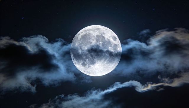 Full Moon Illuminating Wispy Clouds Over Starry Night Sky, Cratered Lunar Surface