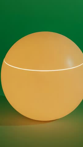 Rotating two-piece glowing sphere with illuminated seam and color shift, vertical loop