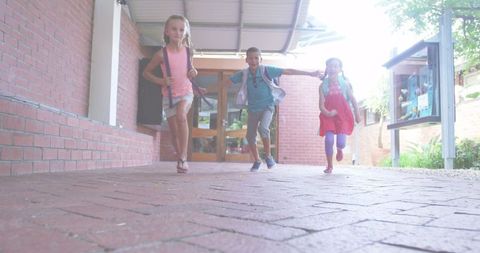 Joyful Children Running to School in Outdoor Corridor