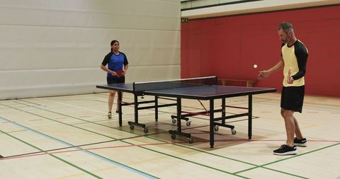 Friends Competing Ping-Pong Enthusiastically Indoor Gym