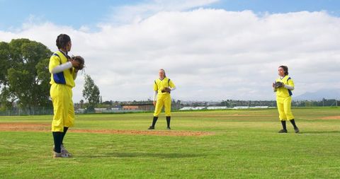 Diverse Female Softball Team Practicing on Field