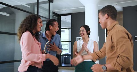 Diverse Colleagues Celebrating Team Success in Modern Office