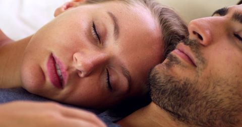 Peaceful couple napping together at home
