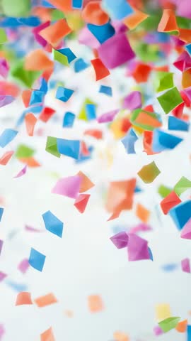 Vertical Confetti Cascade Falling and Drifting on White Backdrop for Celebration Videos