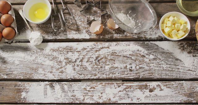 Image of baking ingredients and tools lying on wooden surface with flour. baking, food preparing, taste and flavour concept.