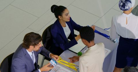 Conference Registration Booth with Business Professionals Engaged