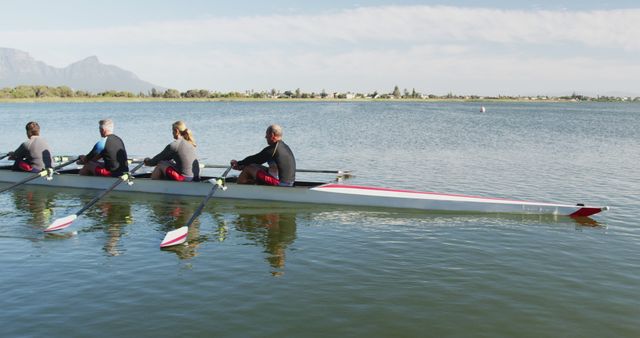 Team of Rowers Exercising in Calm Lake Waters - Download Free Stock Images Pikwizard.com