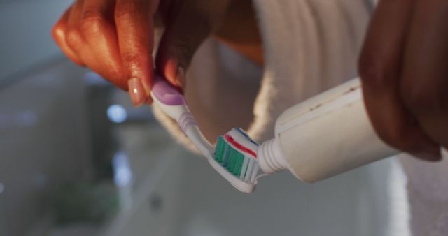 Hands Applying Toothpaste on Toothbrush in Morning Routine - Download Free Stock Images Pikwizard.com