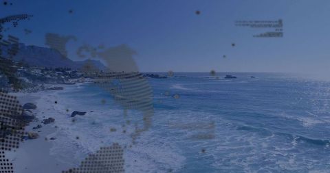Ocean waves crashing on rocky shoreline with halftone world map overlay, drone seascape