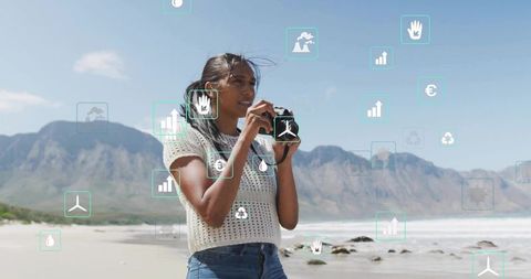 Woman capturing coastal landscape with compact camera and sustainability icons overlay