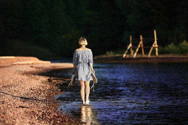 Woman Walking Near Body of Water - Download Free Stock Photos Pikwizard.com