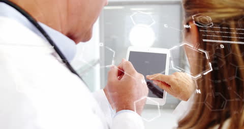 Doctors Discussing Medical Research with Digital Tablet