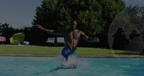 Shirtless man jumping into backyard pool, splashing water in energetic summer swim action