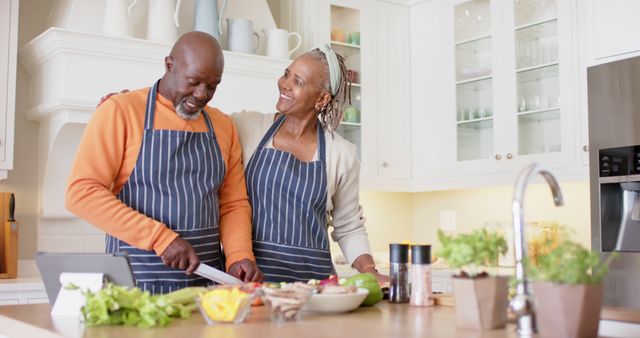 Senior Couple Cooking Together in Kitchen and Smiling - Download Free Stock Images Pikwizard.com