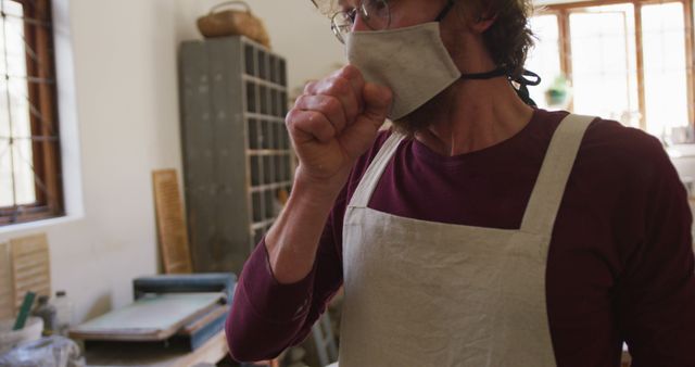 Carpenter Coughing in Workshop Wearing Mask and Apron - Download Free Stock Images Pikwizard.com