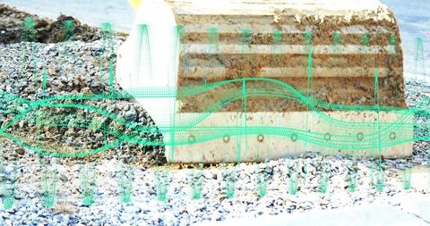 Weathered coastal concrete barrier with augmented reality overlay showing structural data