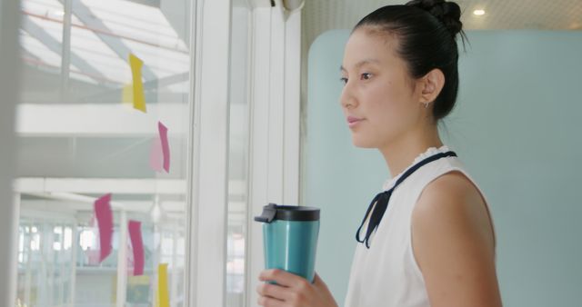 Businesswoman Holding Coffee Mug Relaxing at Office - Download Free Stock Images Pikwizard.com