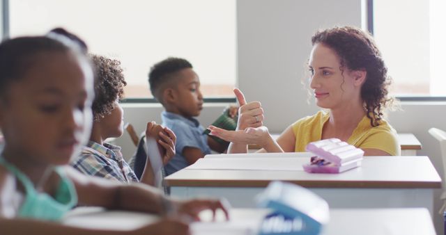 Image of happy caucasian female teacher learning math to african american boy. primary school education and teaching profession.