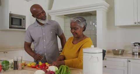 Senior Couple Cooking Together in Kitchen at Home