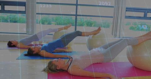 Women performing stability ball bridge in bright studio boosting core strength and balance