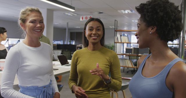 Diverse Female Colleagues Smiling and Talking in Modern Office - Download Free Stock Images Pikwizard.com