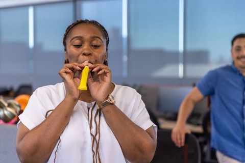 Colleagues Enjoy Office Celebration with Party Decorations