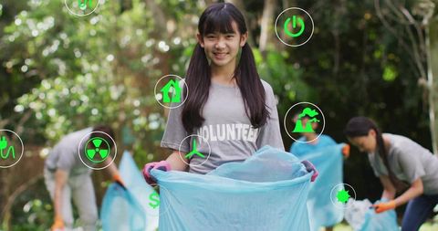 Smiling girl volunteering for environmental clean-up in park