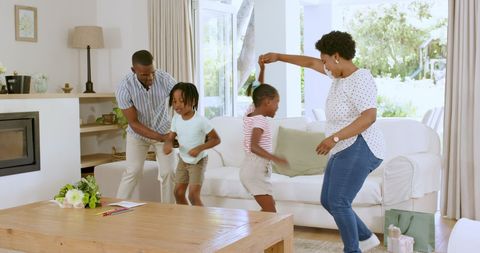 Joyful Family Dancing at Home in Living Room Setting
