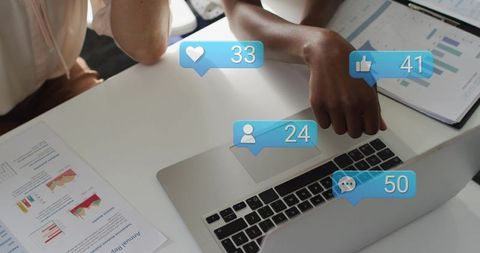 Two women collaborating over laptop with social notifications and analytics dashboards