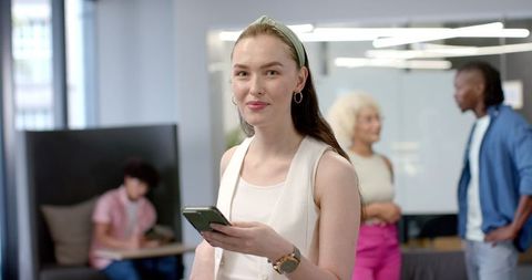 Confident Businesswoman with Smartphone in Modern Office - Download Free Stock Images Pikwizard.com