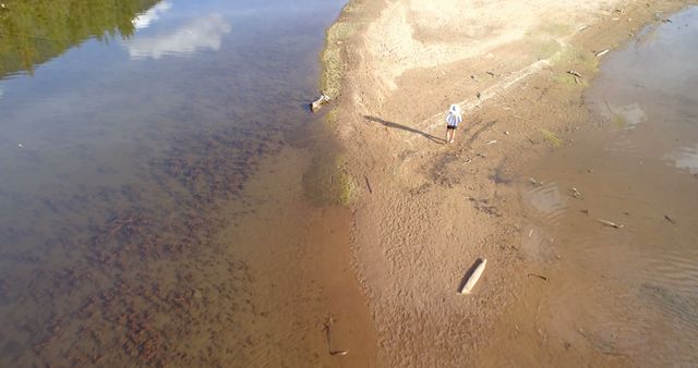 Drone View of Person on Sandy Banks of River - Download Free Stock Images Pikwizard.com