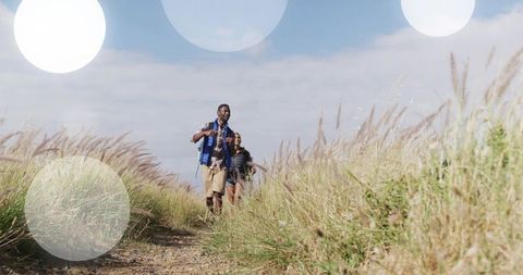 Couple Hiking on Gravel Path through Tall Grasses in Scenic Countryside