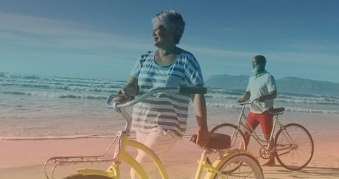 Senior Couple with Bicycles Enjoying Beach Walk - Download Free Stock Images Pikwizard.com