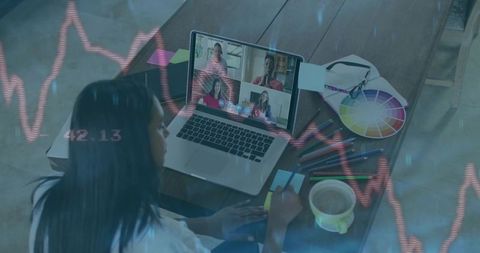 Woman Working Remotely Writing Notes During Virtual Meeting