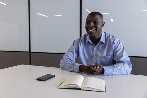 Professional man smiling in a modern office setting